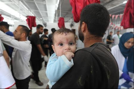 JABALIA, GAZA - MAY 19: An injured baby is seen as the bodies of those lost their lives and the injured in the attack carried out by the Israeli army on the 'Al Hassayna' school d with the United Nations Relief and Works Agency for Palestine Refugees in the Near East (UNRWA) and sheltering displaced people in the Nuseirat Refugee Camp in the central Gaza Strip are being brought to Al-Awda Hospital in Jabalia, Gaza on May 19, 2025. (Photo by Moiz Salhi/Anadolu via Getty Images)