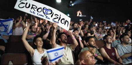 People cheer as they watch the 2025 Eurovision Song Contest finals being screened at a community center in Tel Aviv, Israel, on May 17, 2025. Austria's JJ won the 2025 Eurovision Song Contest on May 18, with his operatic song 
